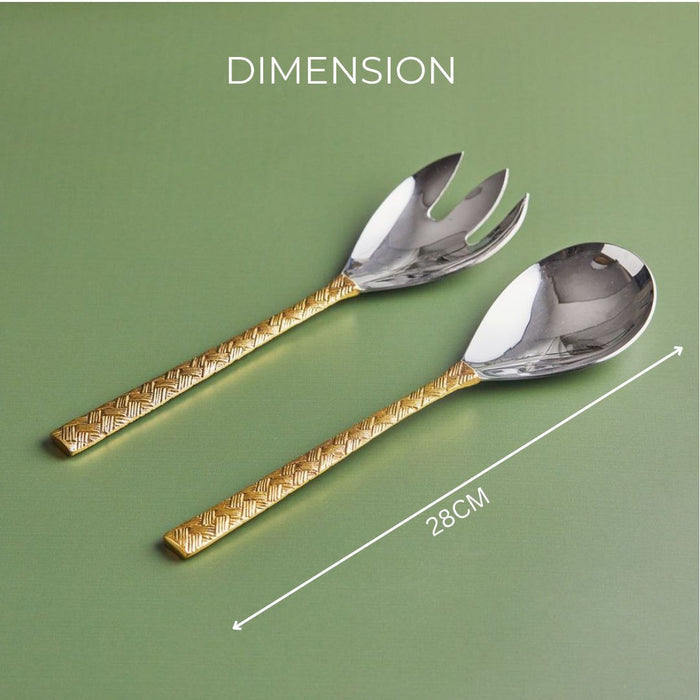 A stainless steel salad server with a brass handle, presented in a green box with a molded interior for each piece.