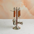 A set of elegant bar tools with wooden handles and shiny metal accents