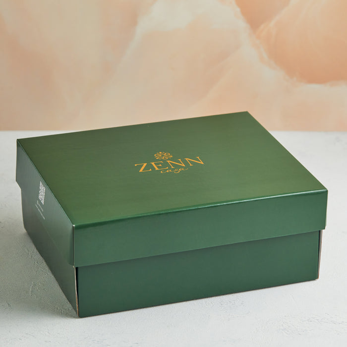 A luxurious green box with a gold "ZENN" logo